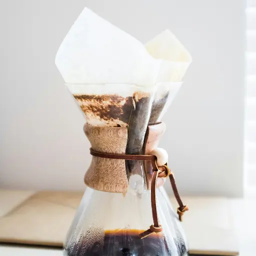 clear glass pitcher on top of brown wooden surface